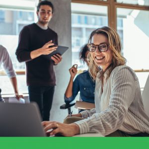 Marketing team working together with a laptop on the desk.