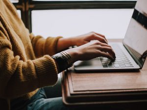 woman typing on computer