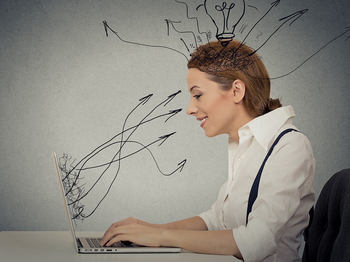 Image of a woman on the computer taking in information