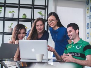 young group of friends looking at a computer