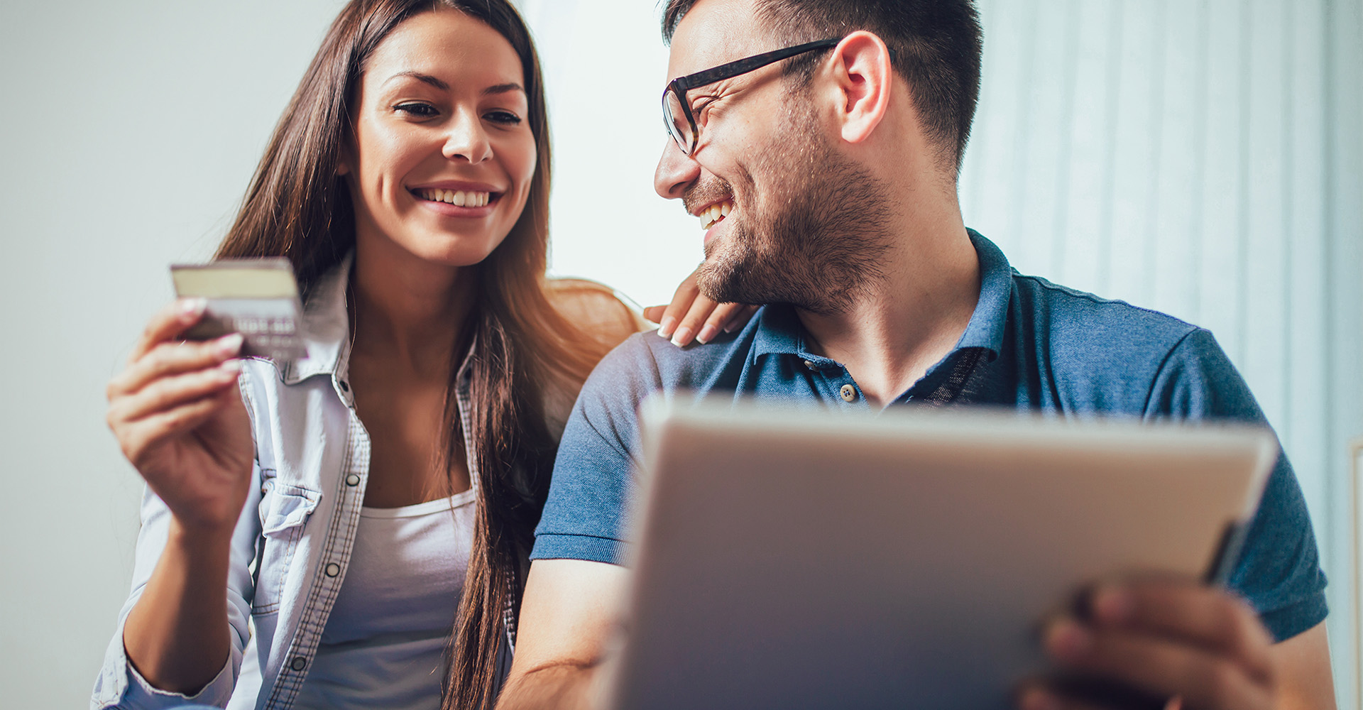 Image of a couple shopping with their tablet