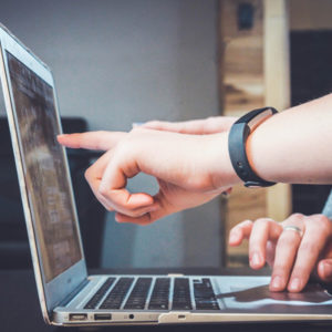 People pointing at a computer screen.